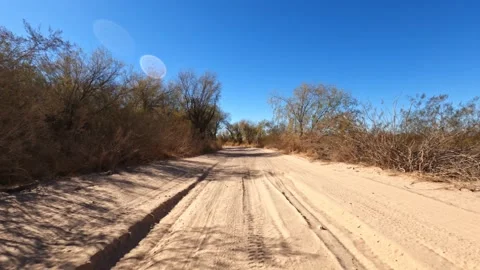 Rugged road trip viewed from front over sandy trail road Stock Footage 147247799