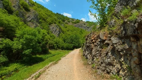 Rugged rock faces line the trail on both sides. Gradasnica River Canyon, Serbia Vídeo Stock 341961815