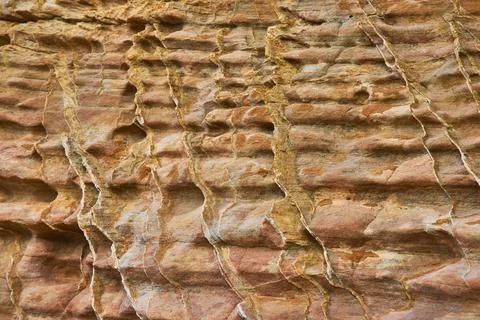 Rugged Rock Texture Close Up With Layered Pattern And Warm Earth Tones 库存照片