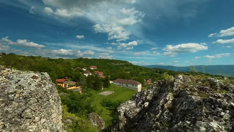 Rugged rocks frame a distant village. Vrmdza Fortress. Serbia Stock Footage 338022088