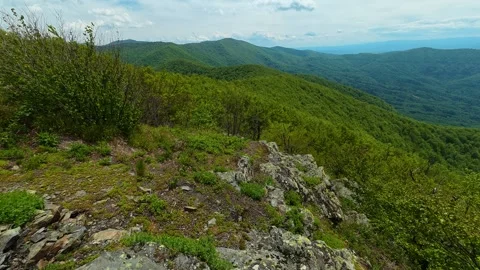 Rugged rocks frame a sweeping green valley. Jastrebac Mountain, Serbia. Video stock 336024502