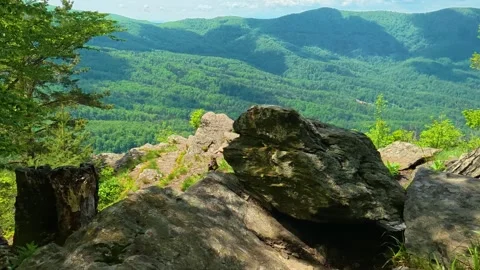 Rugged rocks frame a vast green valley. Jastrebac Mountain, Serbia. Video stock 336024065