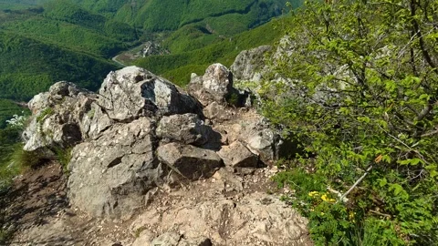 Rugged rocks line a narrow mountain trail. Balkan, Eastern Europe, POV Видео 333841979