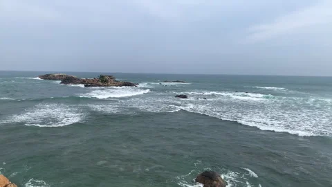 Rugged rocks surrounded by soft ocean waves at Sri Lanka Stock Footage 314852463