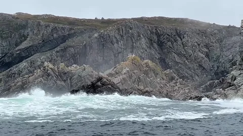 Rugged rocky coastal cliffs with Atlantic ocean waves crashing against the shore 動画素材 343008650