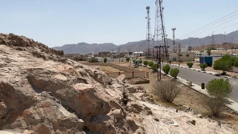 Rugged Rocky Hillside to Modern Infrastructure Stockbeeldmateriaal 334787193