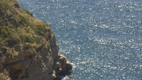 Rugged Sea Cliffs And Sparkling Blue Ocean Waves - Coastal Nature Background 4K Stock Footage 108490374