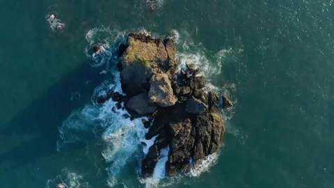 Rugged Sea Stack Aerial: Dramatic Ocean Waves Crashing Against Rocky Islet Stock Footage 319877133