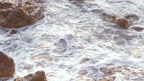 Rugged Seaside Rocks Surrounded by Foamy Ocean Waves at Sunset Stock Footage 340035878