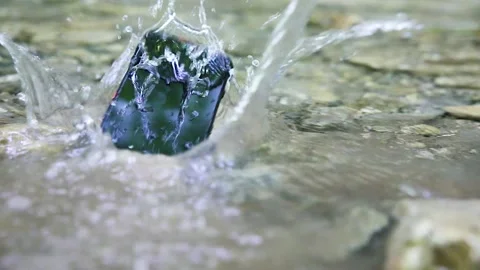 Rugged smartphone drop into the water Stock Footage 149014560