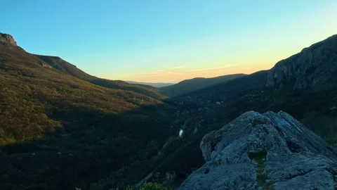 Rugged stone overlooks deep valley at golden hour. Sicevo Gorge, Serbia Видео 332614540
