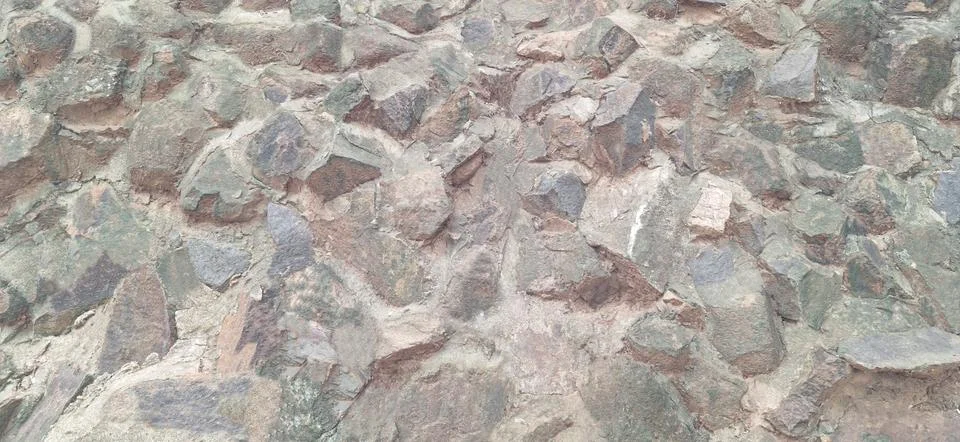 Rugged Stone Wall Texture. Stock Photos