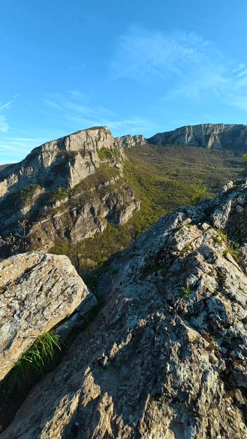 Rugged terrain slopes upward under clear blue skies. Balkan, Eastern Europe, POV Video stock 333636620