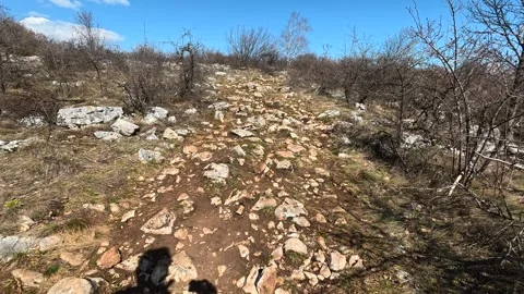 Rugged trail winds through bare hillsides. Balkan, Eastern Europe, POV Vídeo Stock 331782461