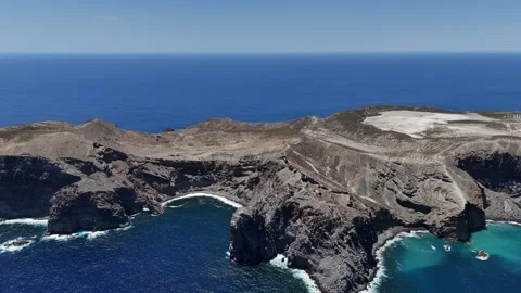 Rugged Volcanic Cliffs and Blue Pacific at Socorro Island, Mexico Stock Footage 344477697