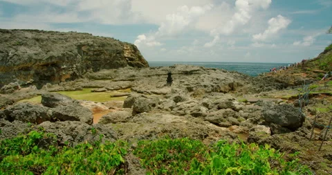 Rugged volcanic rocks and tide pools near ocean at Angel Billabong beach Nusa Stock-Footage 327497901