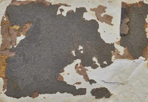 A rugged, weathered paper card featuring heavy peeling layers and rusty tones Stock Photos