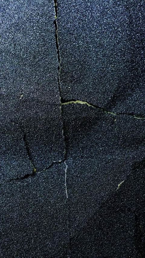 Rugged weathered texture with fissures, dark tones, and mineral patterns Stock Footage 344970974