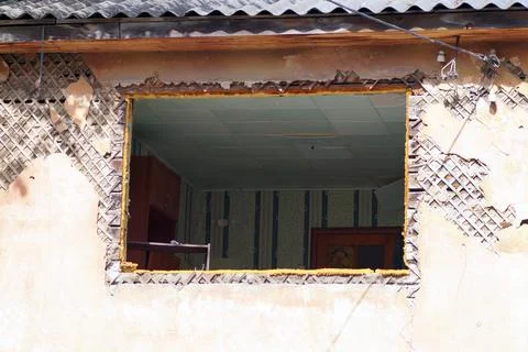 Ruined abandoned house without windows with furniture Stock Photos