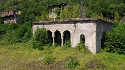 Ruined lost overgrown mining ghost town Akarmara, consequences of war in Stock Footage 152554599