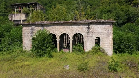 Ruined lost overgrown mining ghost town Akarmara, consequences of war in Stock Footage 152970417