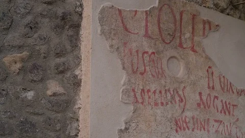 Ruined scriptures on the wall in Pompeii Italy Stock Footage 88015356