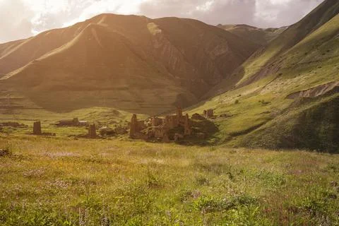 Ruined tower complex in high mountains at sunset . North Ossetia Alania , R.. Stock Photos