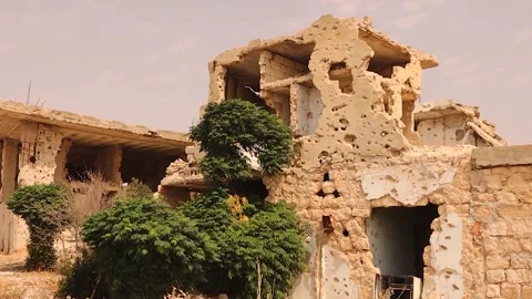 Ruined war-torn building with bullet holes and debris in Aleppo, Syria Stock Footage 317364357