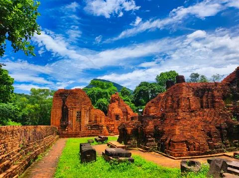 Ruins of ancient structures under a blue sky and bright clouds Stock Photos