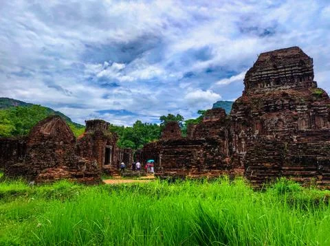 Ruins of ancient structures with visitors exploring the site on a cloudy day 写真素材