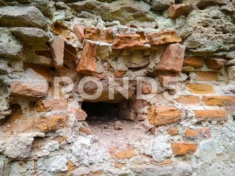 Ruins and old brick wall close up. Broken ancient brick wall with hole ...