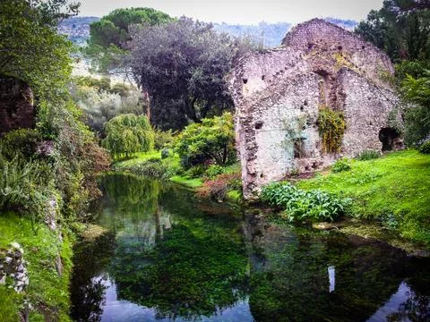 Ruins and reflection in Giardini di Ninfa, in Italy Stock Photos