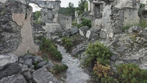 Ruins and remains of houses of the destroyed city. Camera moves between rubble Stock Footage 154262213