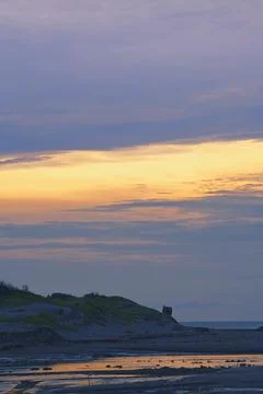 Ruins on the beach at sunset Stock Photos