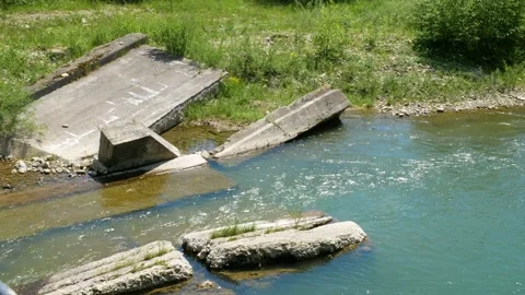 Ruins of a bridge in a river Stock Footage 130797334
