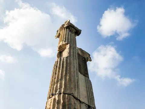 Ruins of ionic column against blue sky Stock Photos