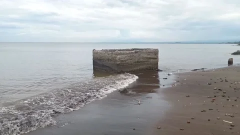 The ruins of an old cube building on the beach Stock Footage 231383239