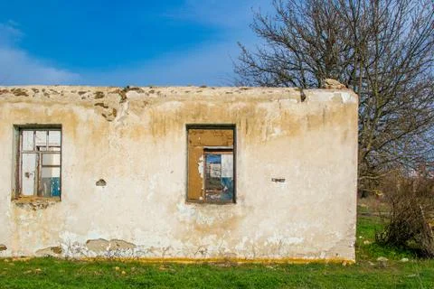 The ruins of an old earthen house without a roof. Stock Photos