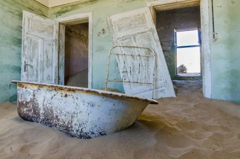 Ruins of once prosperous German mining town Kolmanskop in the Namib desert near Stock Photos