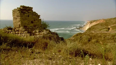 Ruins set on grassy cliffs with Mediterranean Sea behind Video stock 95600723