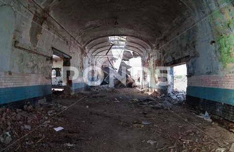 Ruins, view of an old abandoned industrial interior Stock Photos
