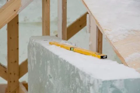 The ruler with the level on the ice block Fotos Stock