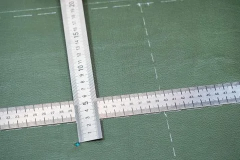 Rulers on surface of leather with drawn pattern Stock Photos