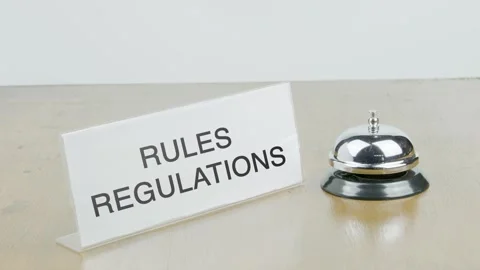 Rules and Regulations Office or Room with Hand Ringing The Bell on Desk Stock Footage 300812499