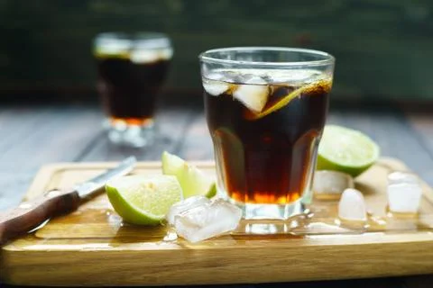 Rum and cola refreshing Cuba Libre alcohol cocktail with lime an Stock Photos