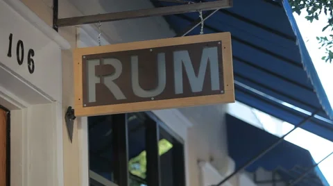 Rum Sign Under a Blue Awning that is Blowing in the Wind Stock Footage 61839796