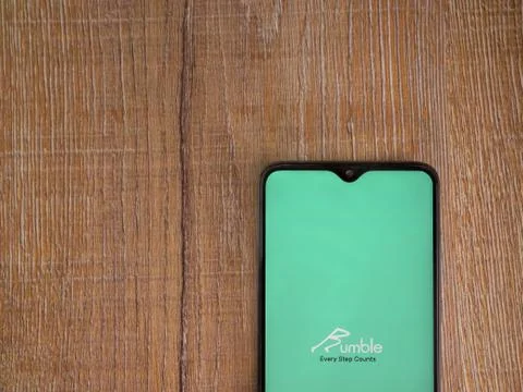 Rumble app launch screen with logo on the display of a black mobile smartphon Stock Photos