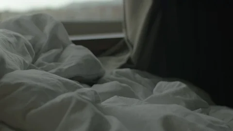 Rumpled blanket on bed in the morning Stock Footage 70599864