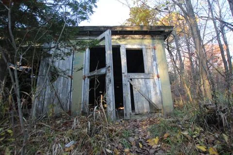 A run down building in the fall woods Stock Photos