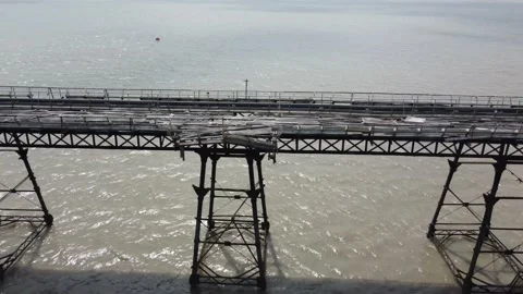 A run down dilapidated pier that is near to collapse.  Aerial view. Stock Footage 224283381